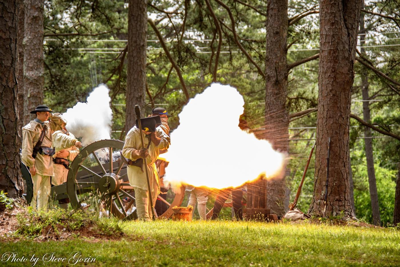 Alamance Battleground to Host ‘Fight for the Backcountry,’ the Battle of Alamance Re-enactment May 16. Image of re-enactors firing a cannon.