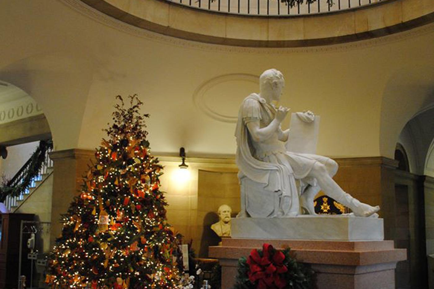 The interior of the State Capitol building, adorned in Christmas decorations.