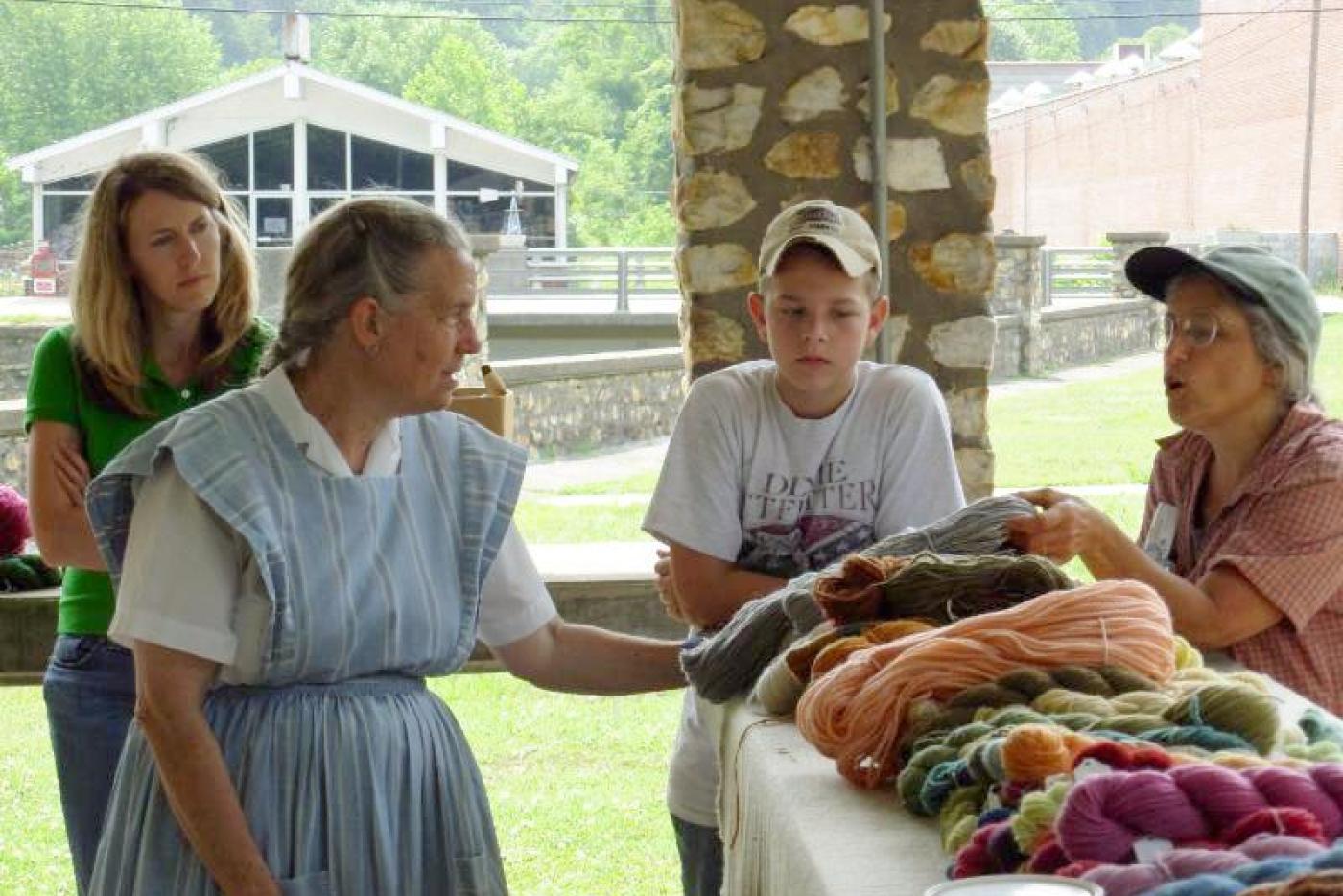 Historical interpreters examining yarn.