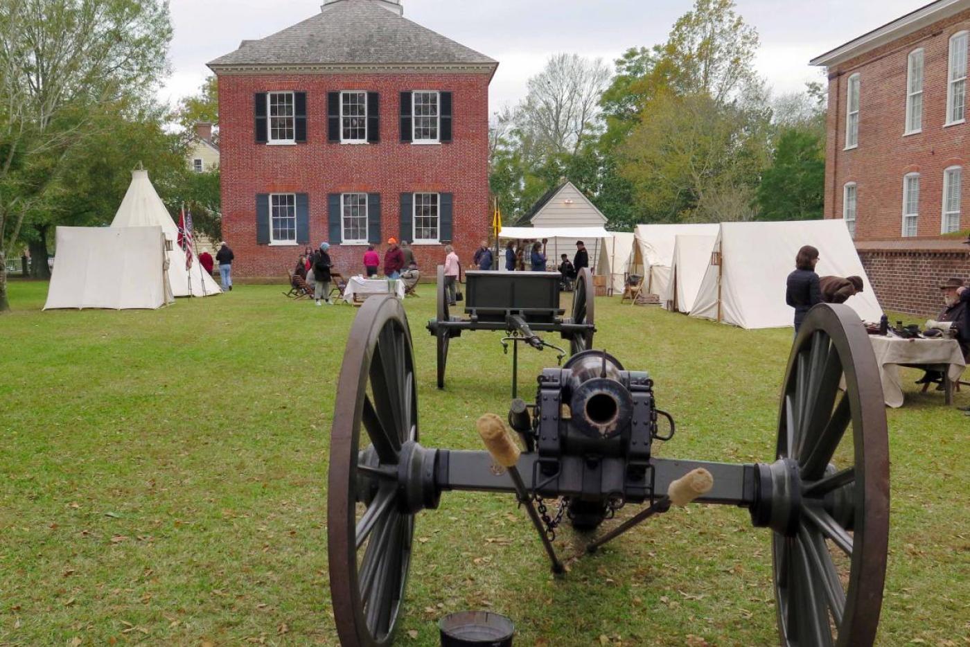 Historical interpreters, tents, and cannons outside of Tryon Palace.