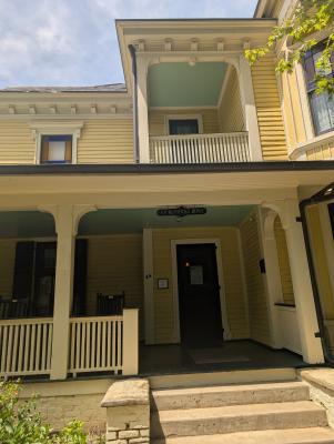 the exterior of a large, yellow historic house