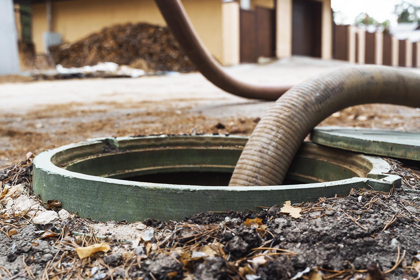 A hose is used to pump a septic system.
