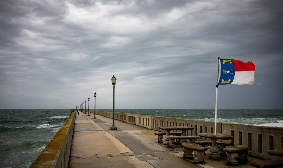 The NC flag flies in strong winds as Hurricane Isaias makes landfall at Wrightsville Beach in 2020.