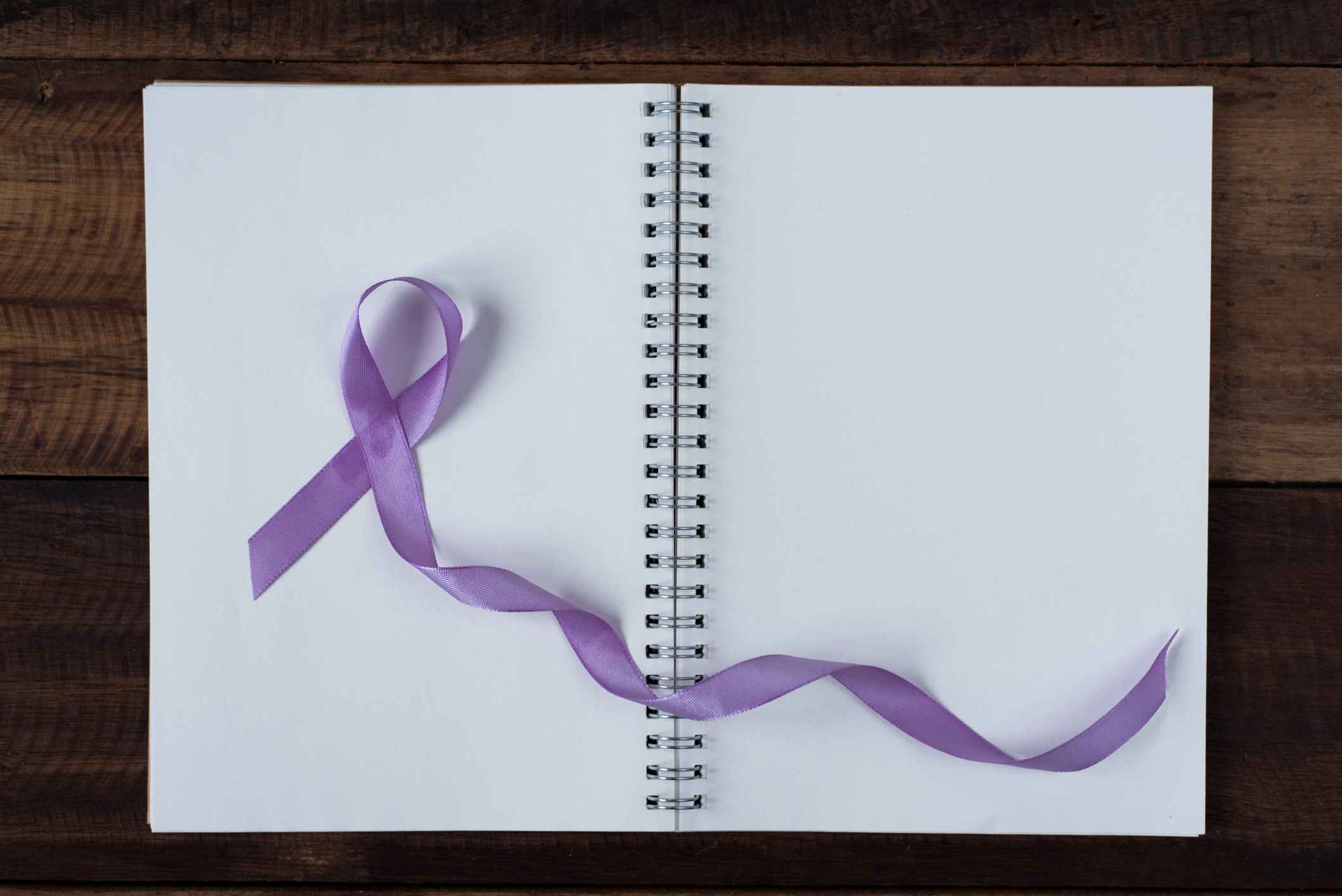 Purple ribbon on an open notebook.