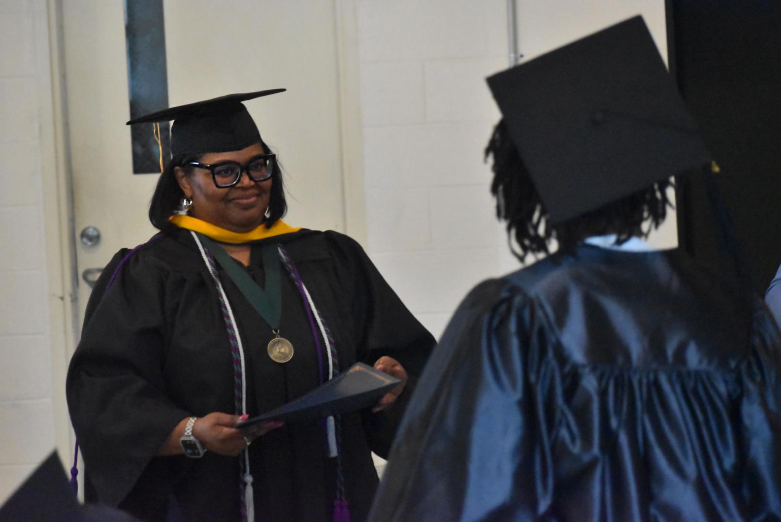 Teacher congratulates student on graduation