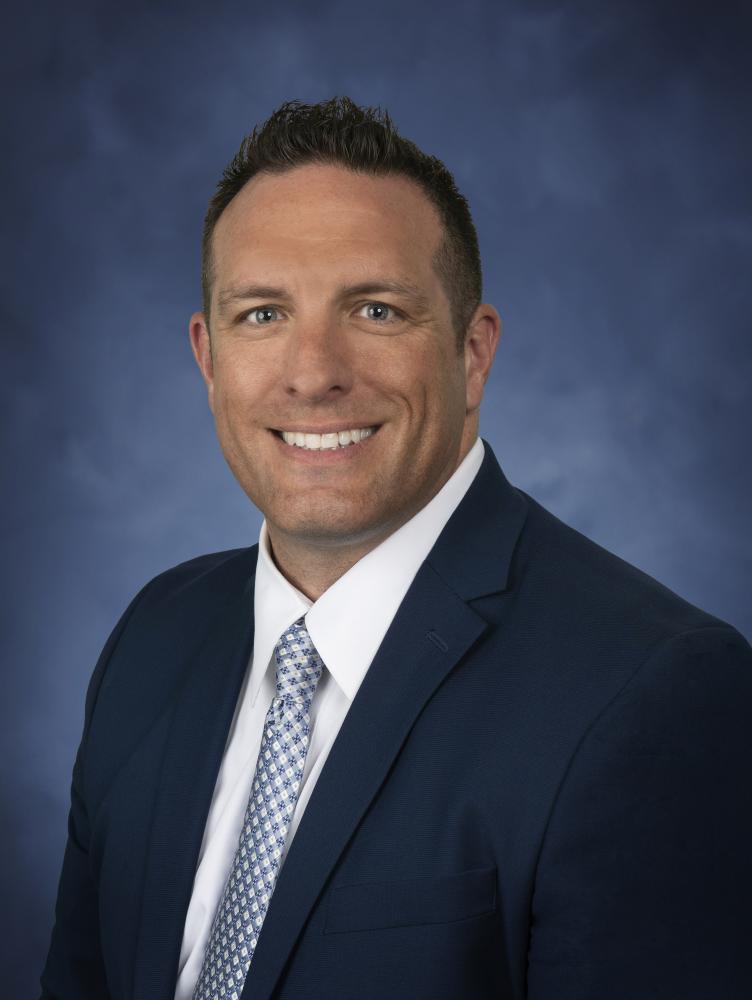 Jody Donaldson in front of blue background