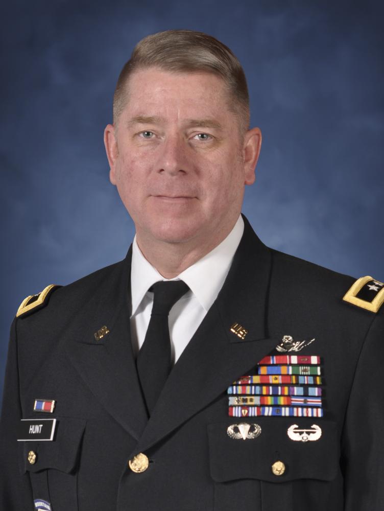 Todd Hunt dressed in uniform in front of blue background.
