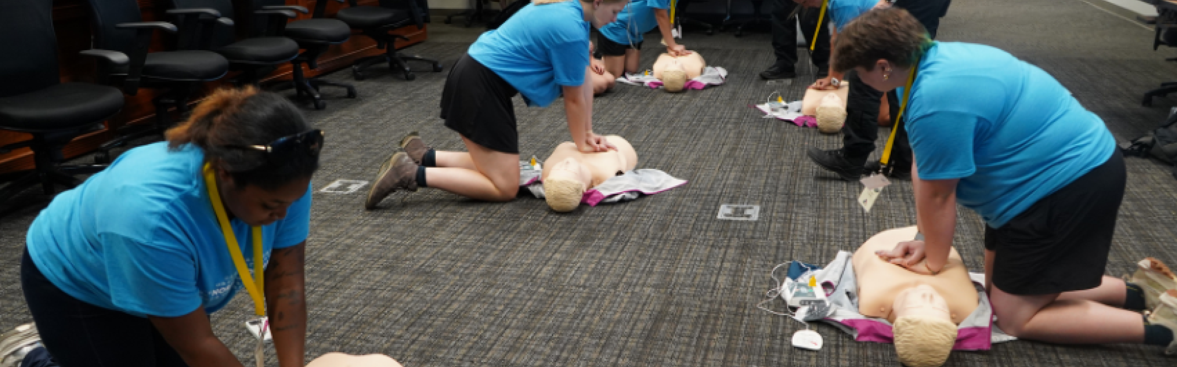 Young women performing CPR on mannequins. 