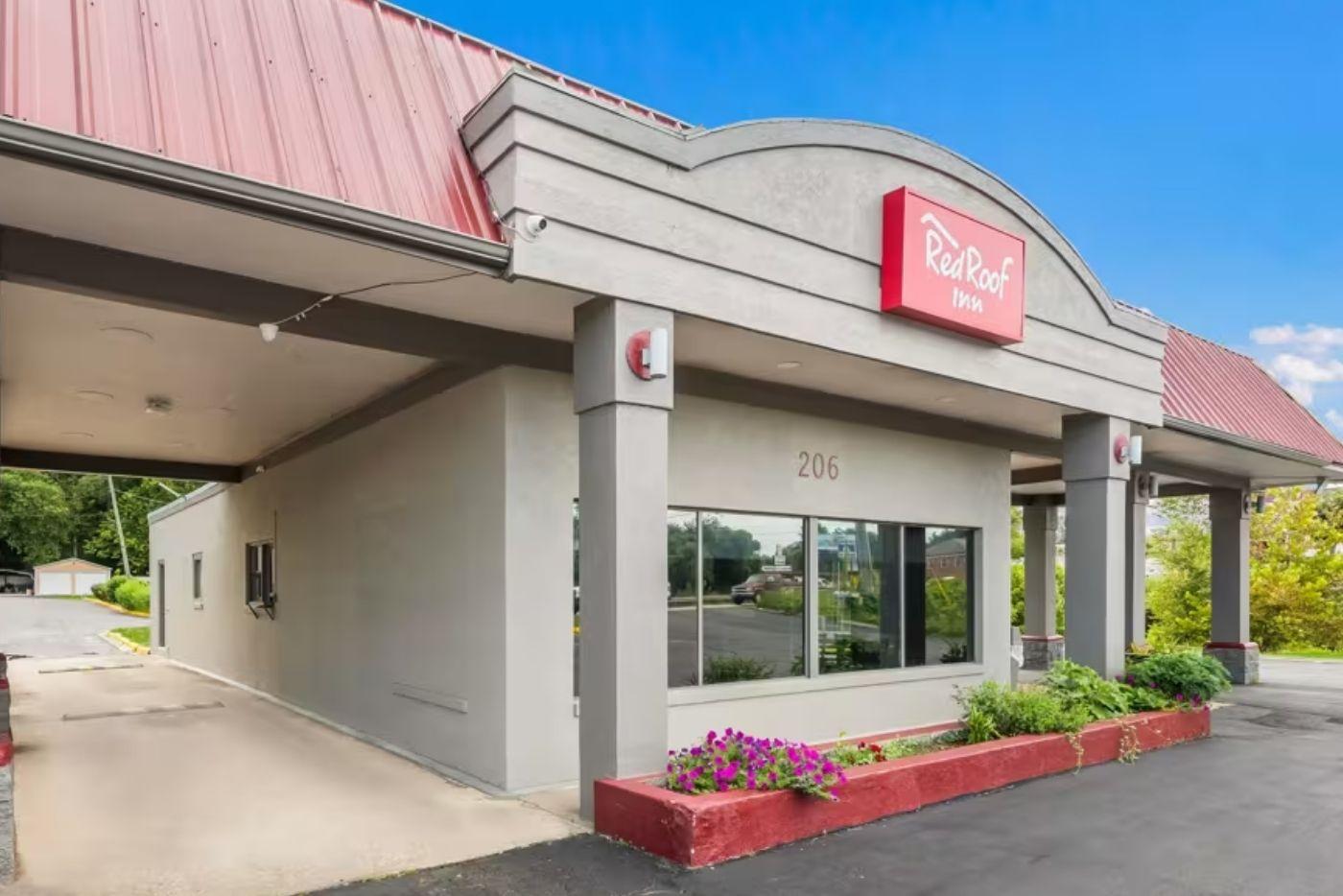 Red Roof Inn. Tan and grey building with red siding.