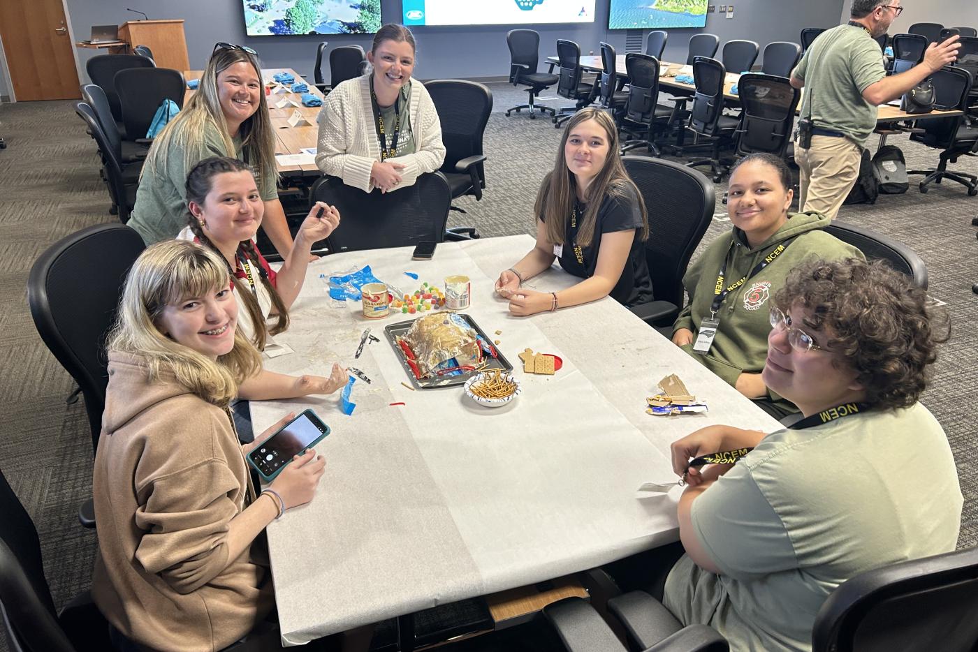 Seven women sitting at a table doing an activity together