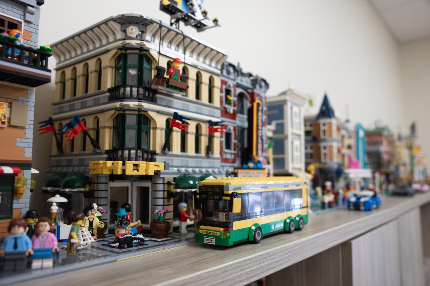 A detailed LEGO cityscape with vehicles, mini-figures in different activities.