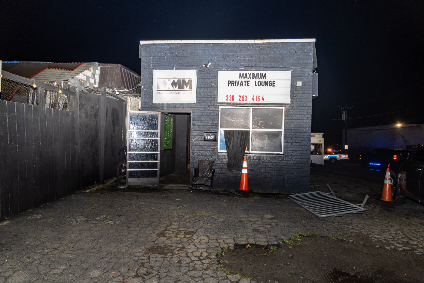 Black brick square building with white sign that reads Maximum Private Lounge