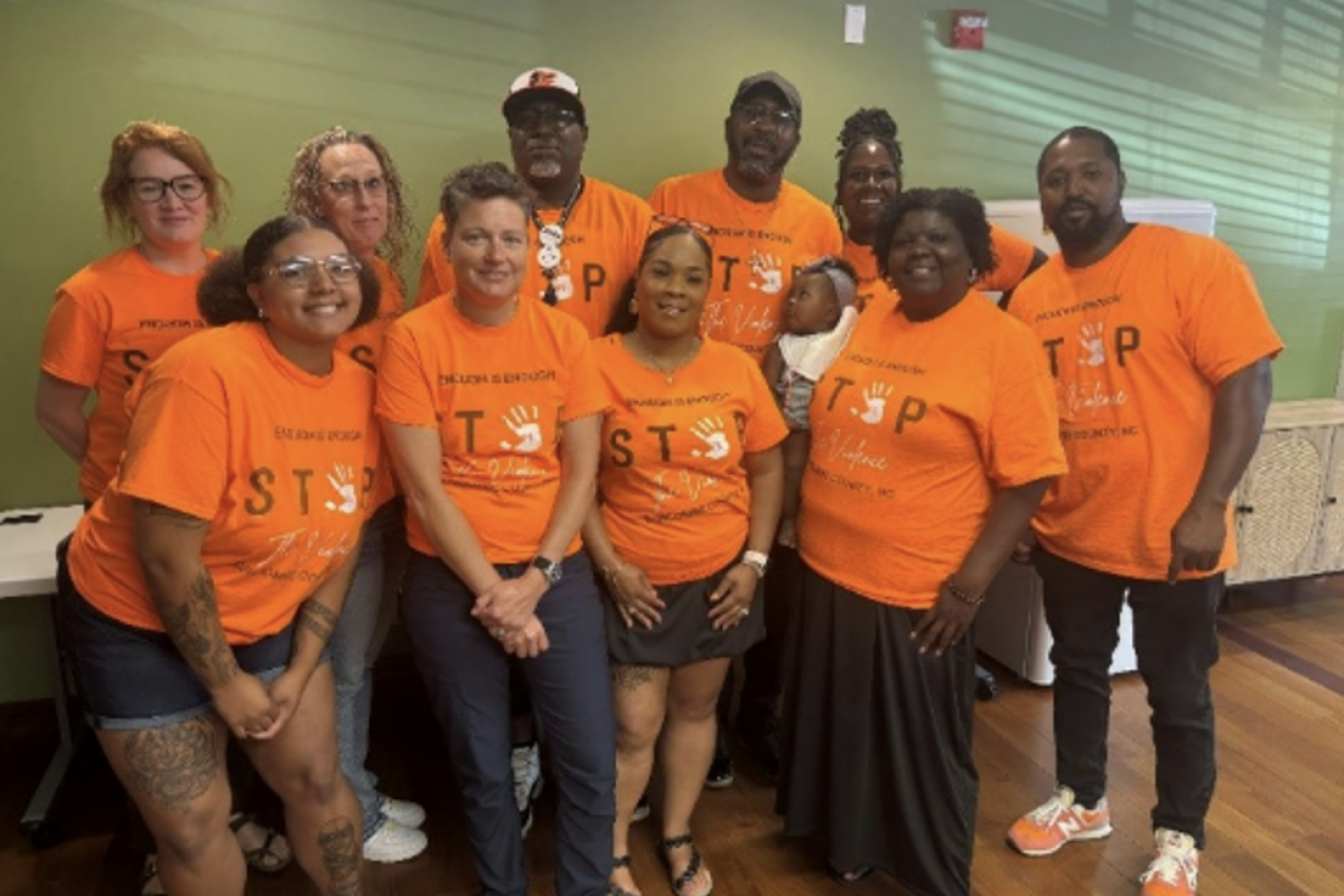 Group of people wearing matching orange shirts