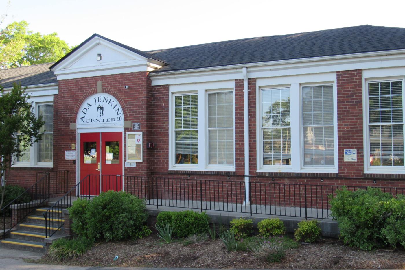 Photo of brick building with red doors