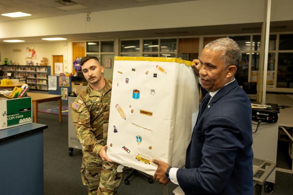 Secretary and soldier team lift