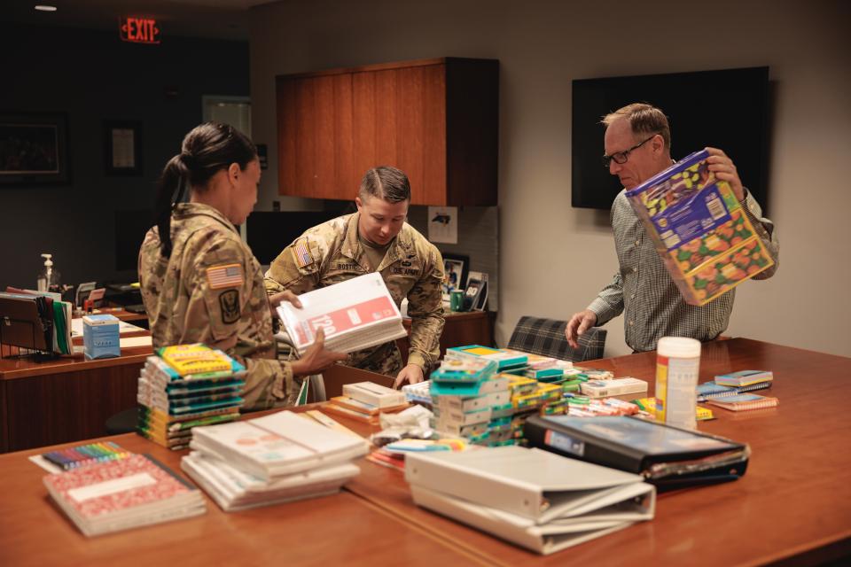 Soldiers loading school supplies