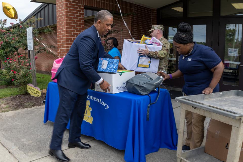 Group unloading school supplies