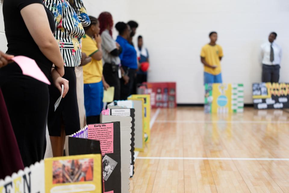 Youth present on historical figures during wax museum event