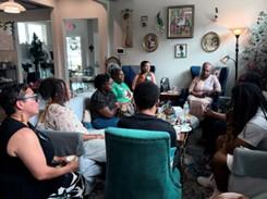 Group of people sitting in living room having a conversation