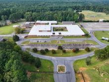 Aerial view of a building with a field nearby.