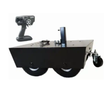 Black box on wheels with a controller next to it.