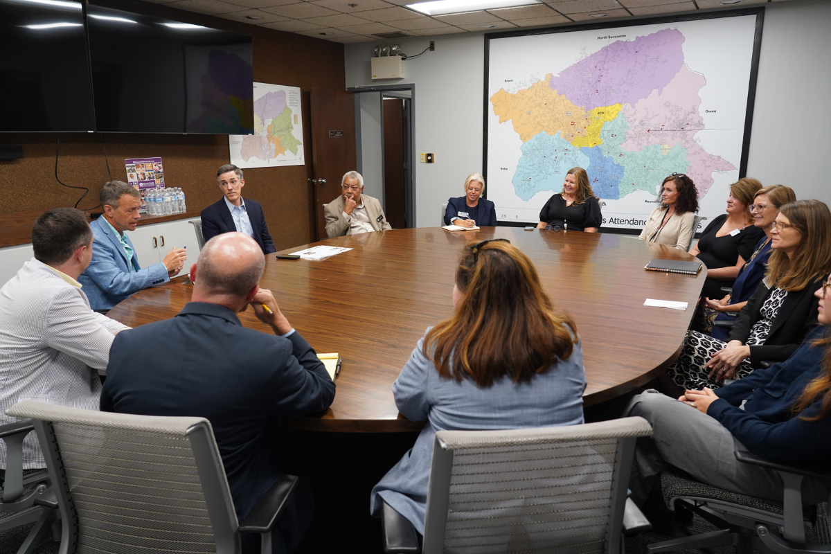 school leaders meet around a large table