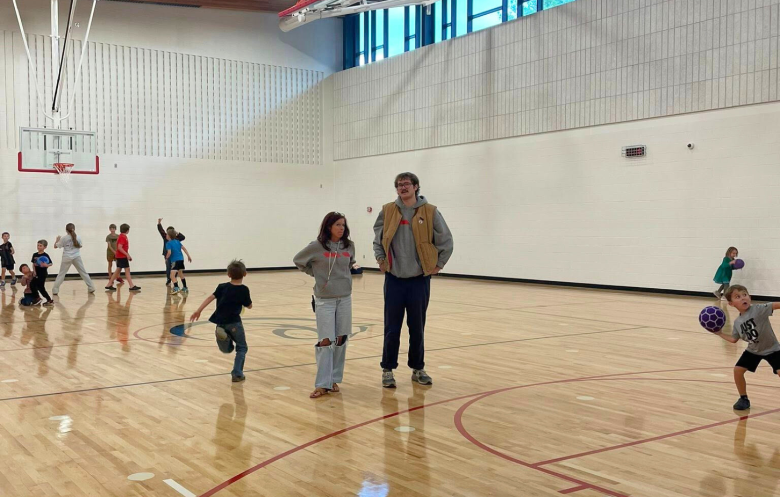 A classroom of young students in an elementary school gymnasium