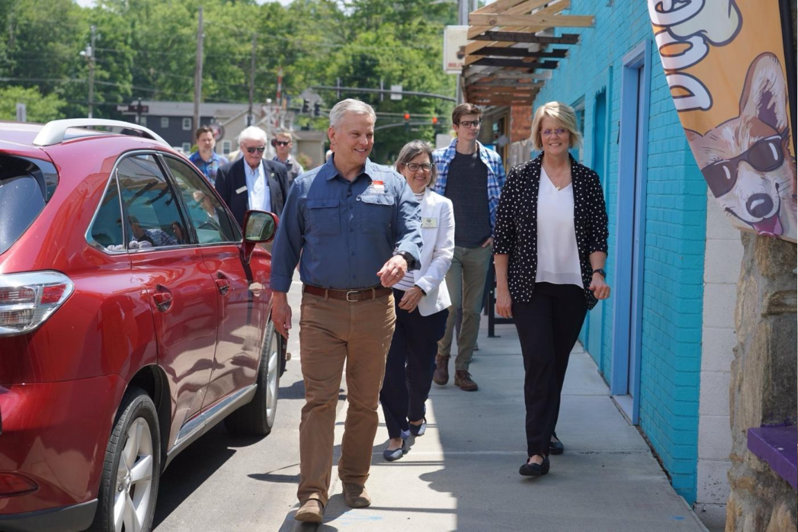Leaders walking down a sidewalk