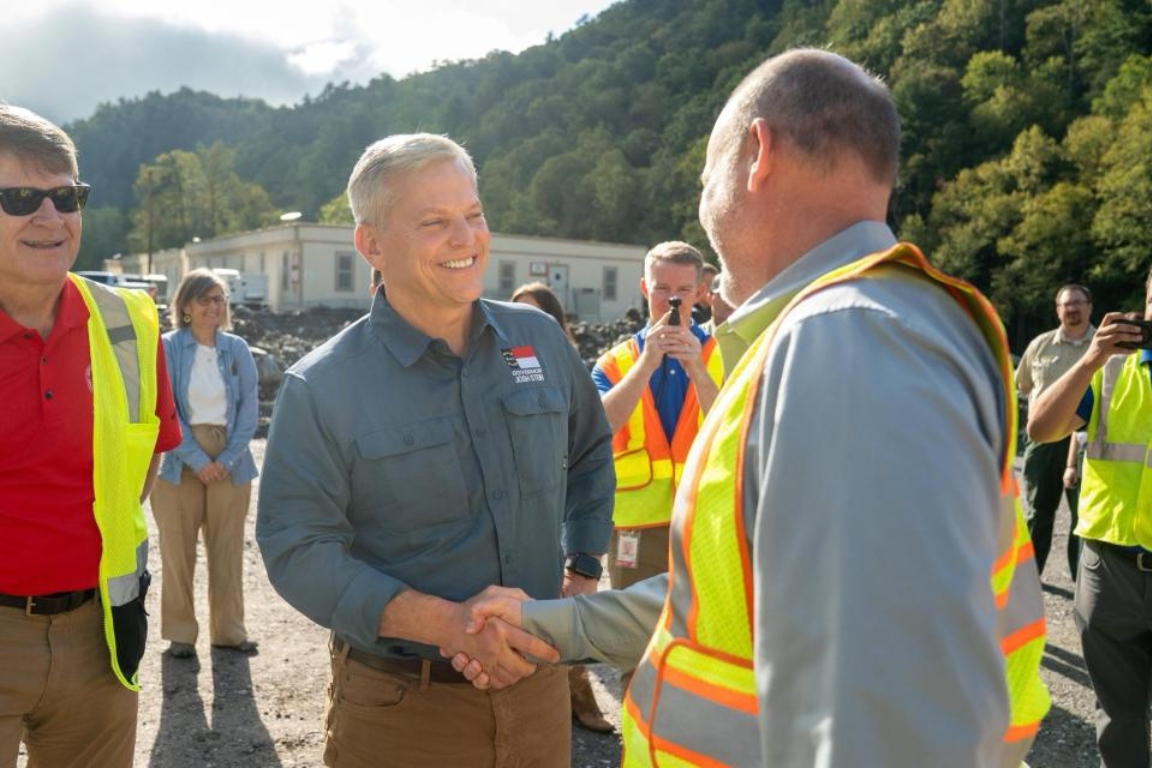 Leaders shake hands in an outdoor setting