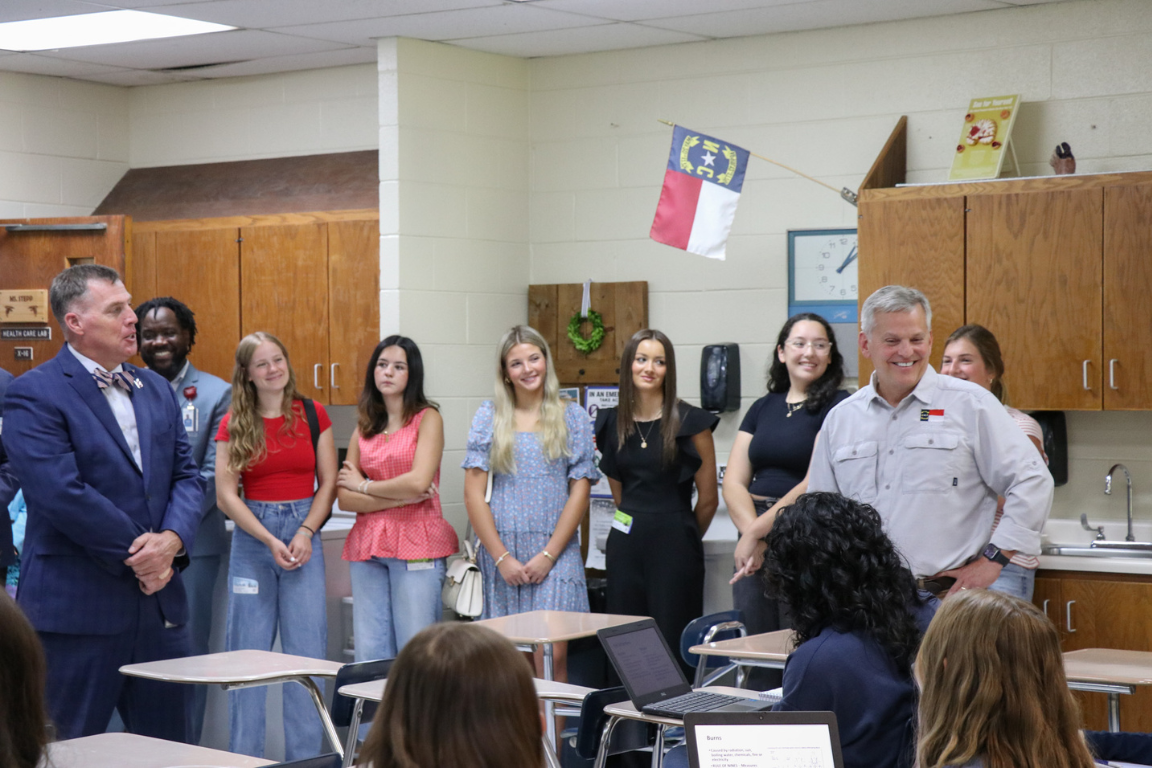 Leaders gather with students in a classroom setting