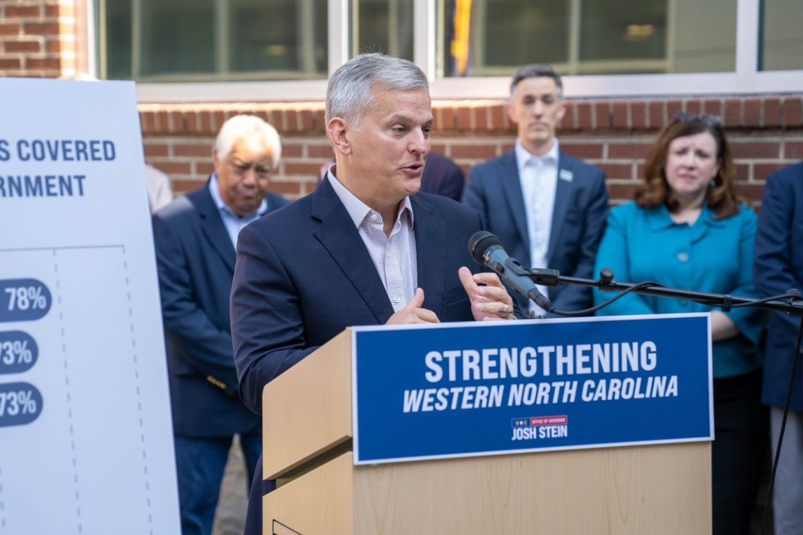 State leader stands at a podium speaking into a microphone