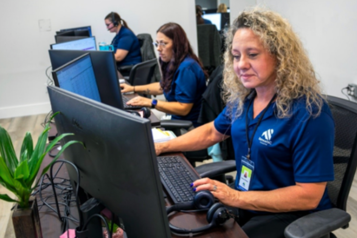 A group of employees working at desks with computers
