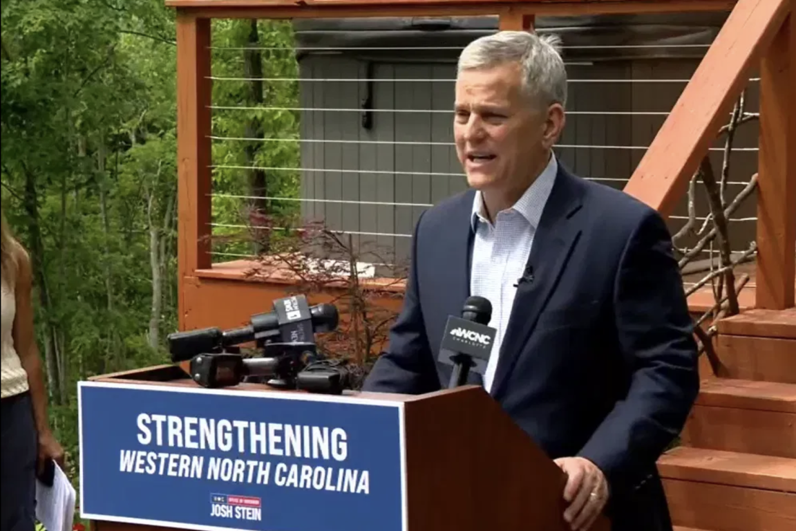 state leader speaks at a podium in an outdoor setting