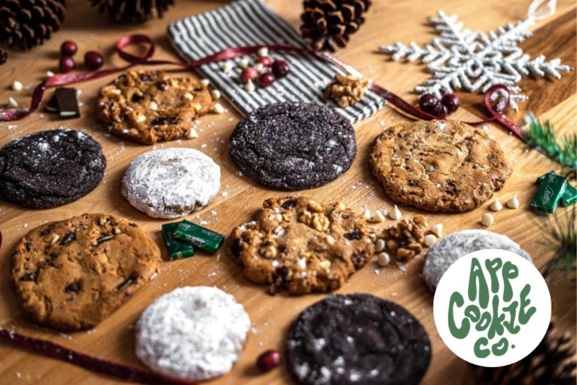 Freshly baked cookies on a wooden countertop with holiday decorations