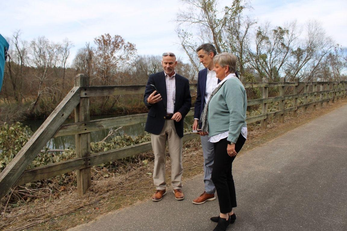 Three people in business attire on a local greenway