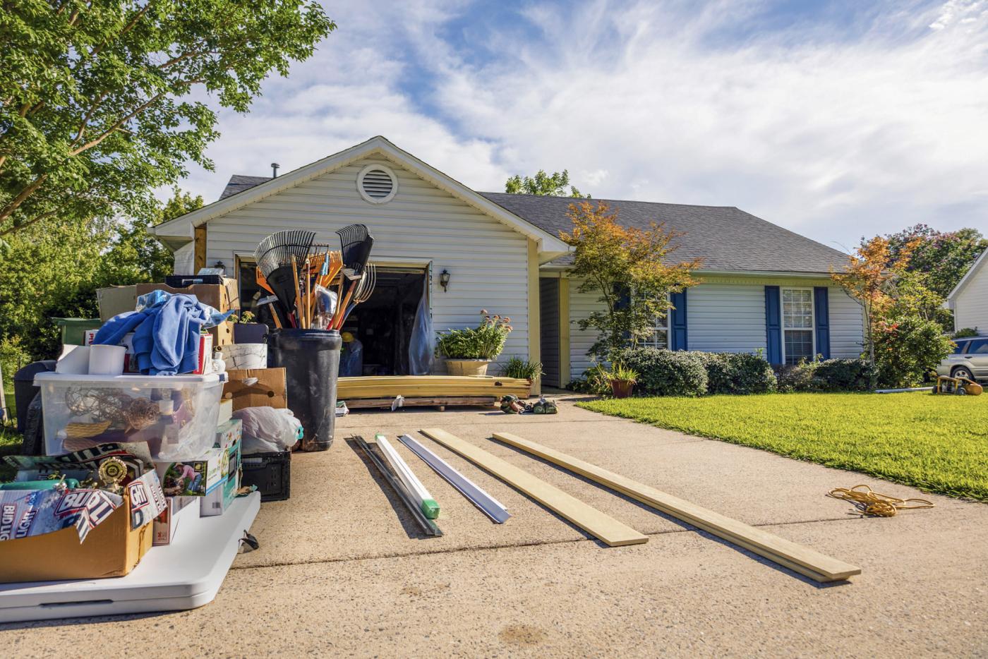 Newly repaired home with construction materials in the driveway