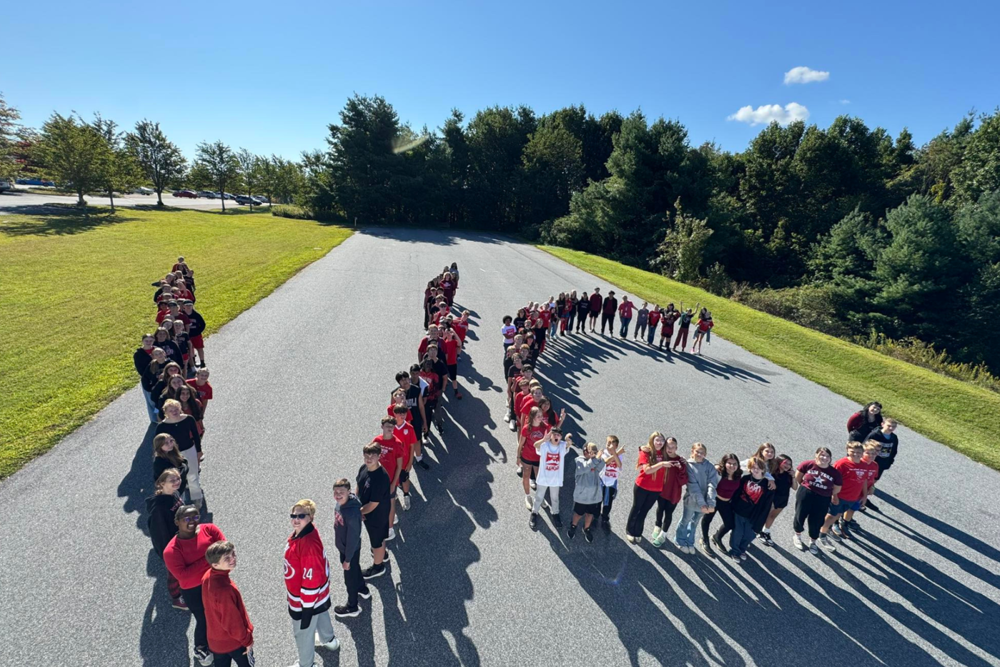 students spell the letters V and C at outdoor recess