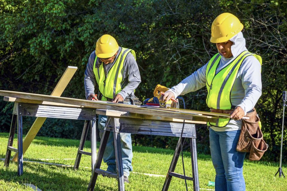 Home construction crew preparing materials