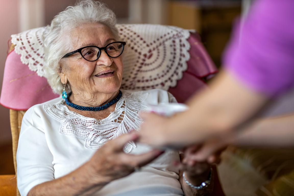older adult woman getting a cup of tea