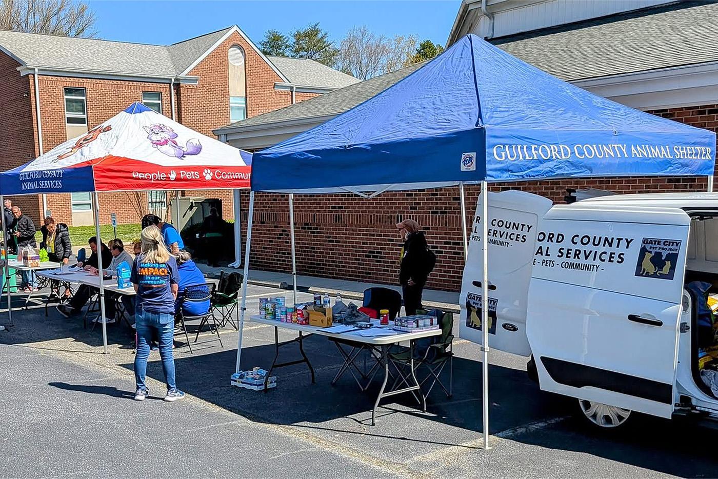 Mobile Pet Assistance Clinic event set up with tents and tables outdoors.