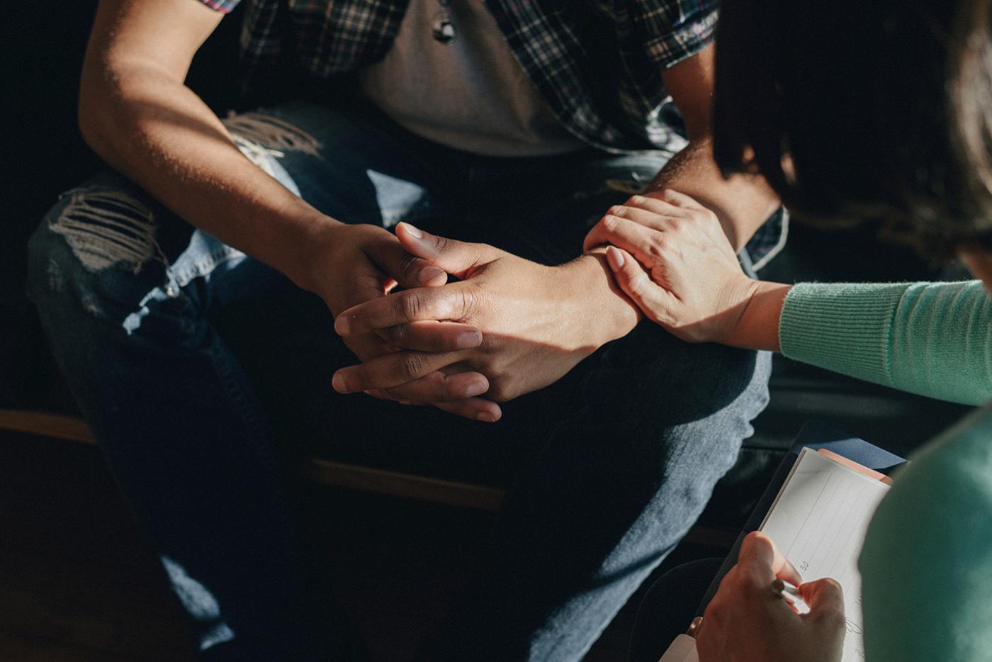 People supporting each other during a therapy session.