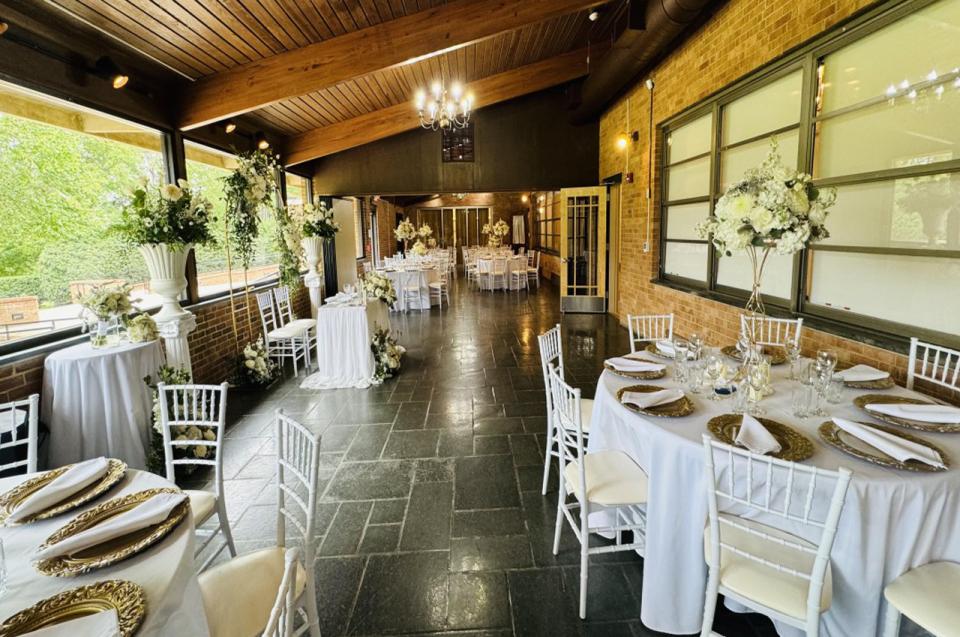 The Lake Room at Bur-Mil Park Event Center featuring tables with white tablecloths and chairs.
