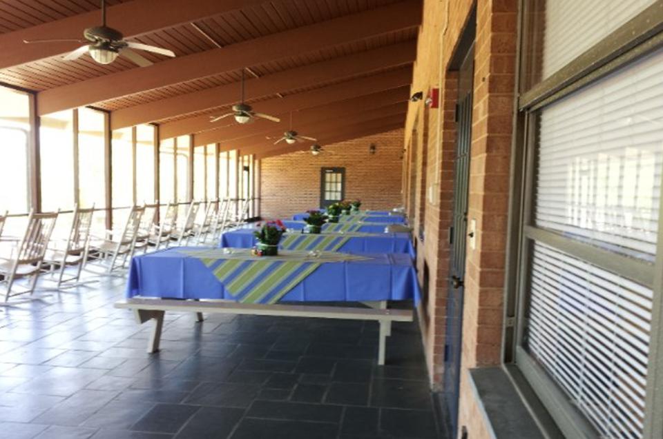 The Porch at Bur-Mil Park Events Center featuring chairs and picnic style tables.