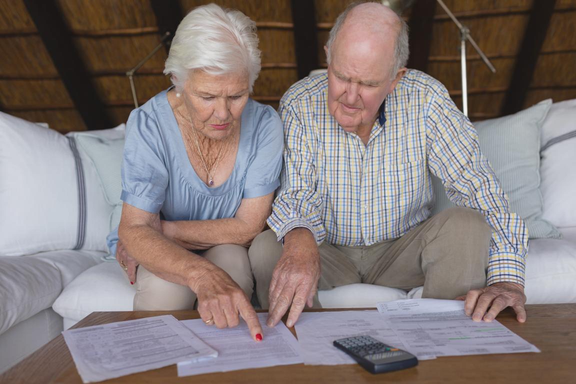 Man and woman looking over papers with calculators