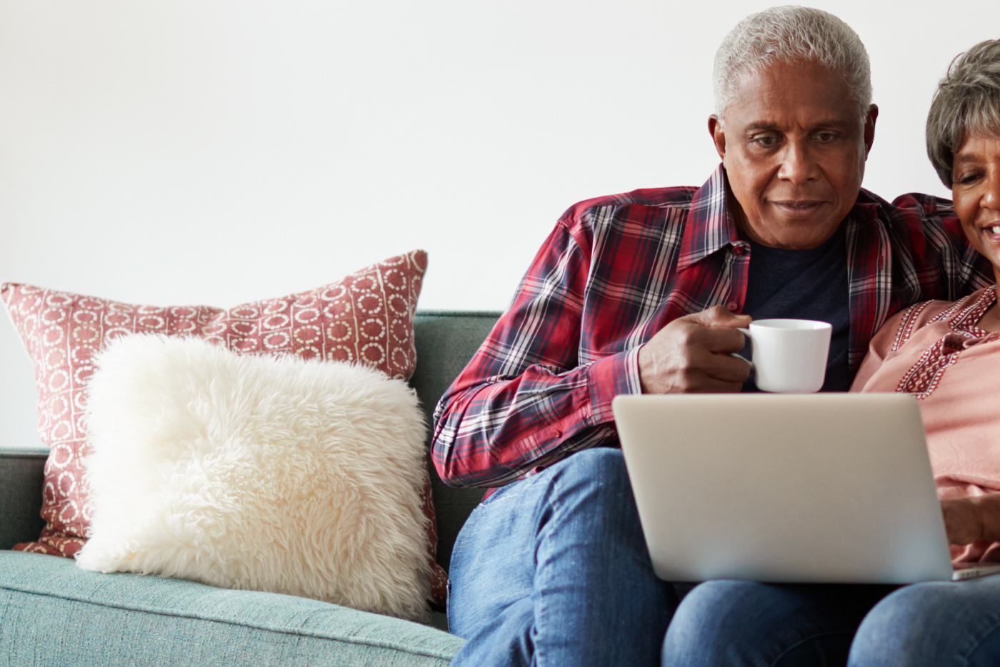 Senior Couple on Couch with Laptop