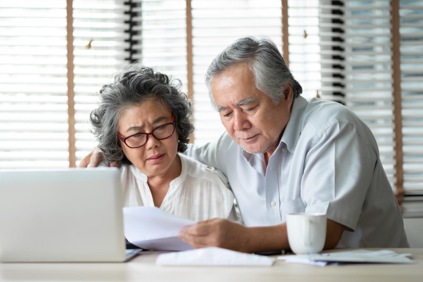 Concerned mature couple on laptop