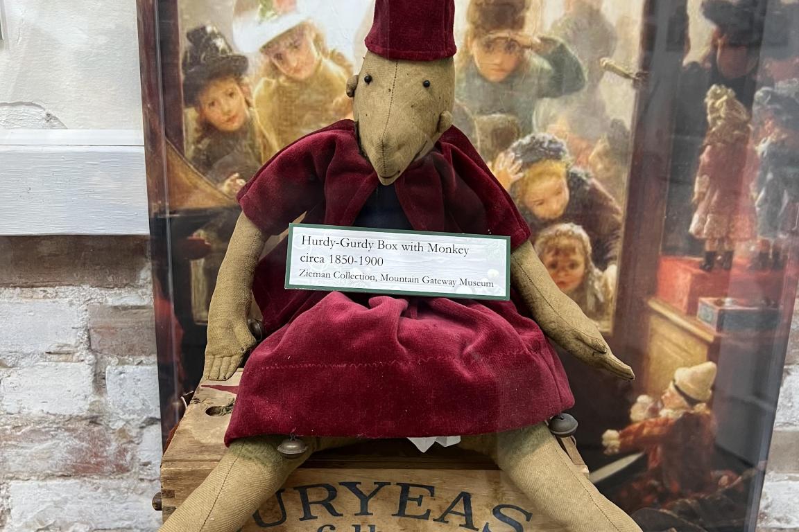 Hurdy-Gurdy Box with Monkey in exhibit case