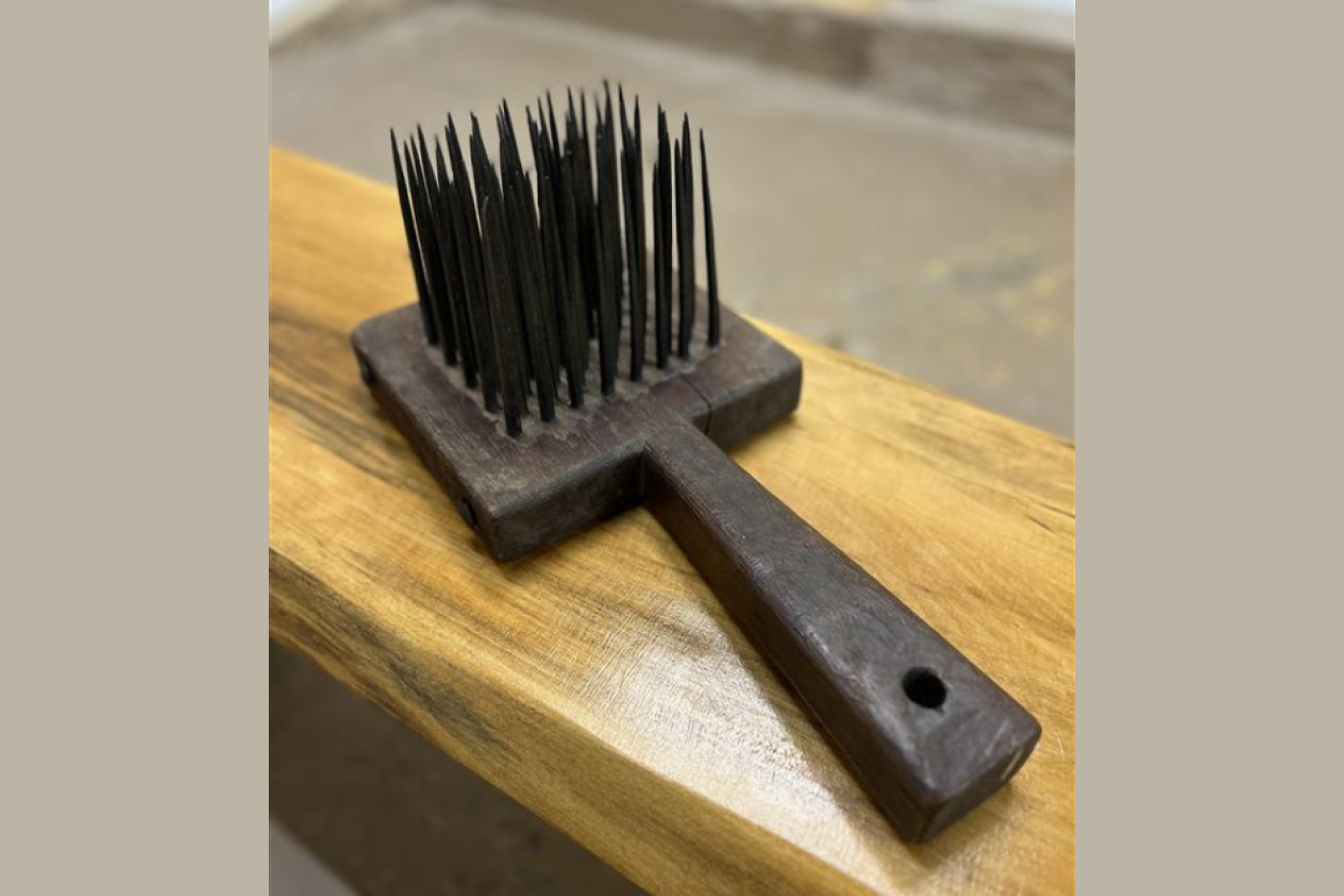 Wooden flat object with sharp spikes on one side.