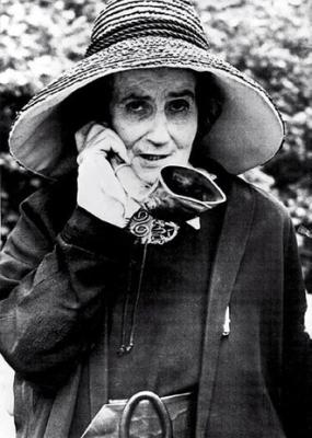 woman holding an ear horn to her ear