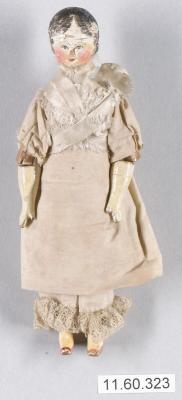Old porcelain doll with beige clothing